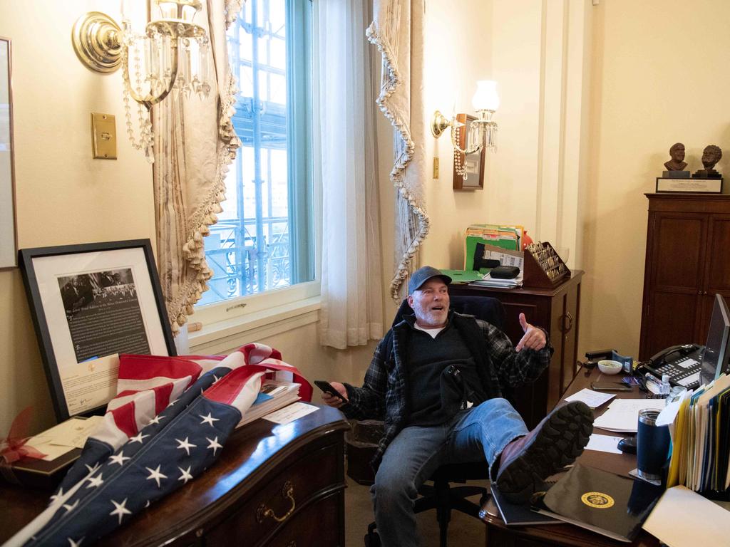 Barnett sitting at Nancy Pelosi’s desk, an image that immediately went viral. Picture: SAUL LOEB / AFP