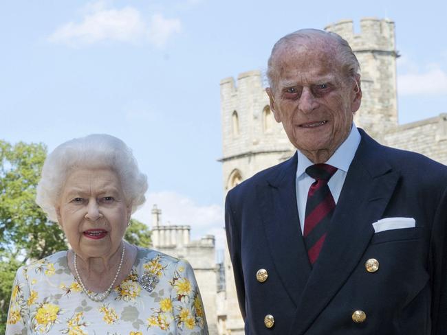 Britain's Queen Elizabeth II and Prince Philip the Duke of Edinburgh pose for a photo June 1, 2020, in the quadrangle of Windsor Castle, in Windsor, England, ahead of his 99th birthday on Wednesday, June 10. The Queen is wearing an Angela Kelly dress with the Cullinan V diamond brooch, while Prince Philip is wearing a Household Division tie. (Steve Parsons/Pool via AP)