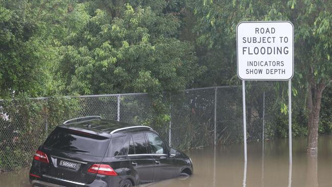 Flooding on the Gold coast in the aftermath of Cyclone Alfred. A Mercedes in a watery grave in Chisolm Rd.. Picture Glenn Hampson