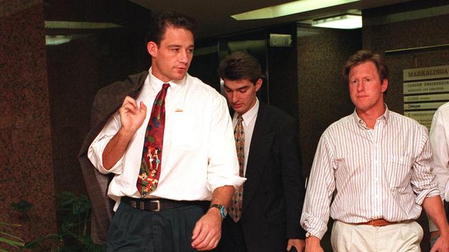 Former Western Reds player Mark Geyer (L) leaves tribunal in Perth, WA with his advocate Damian Gare &amp; coach Peter Mulholland (R) in 1996. 