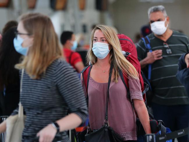 Terminal 2 at Sydney Airport Departures this morning as travellers look to get out of Sydney as Covid cases increase on the Northern Beaches and Central Coast. Crowds start to build at the Jetstar queue. Picture: David Swift