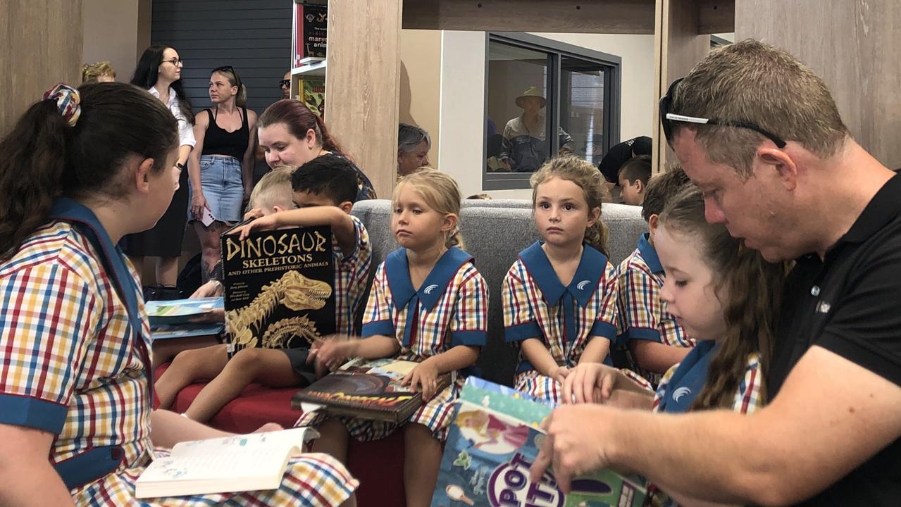 The first day of school in prep at Queensland’s newest primary school Scenic Shores State School for Lucy Jamieson who is reading a book with dad Trent Jamieson. Pictures; JUDITH KERR