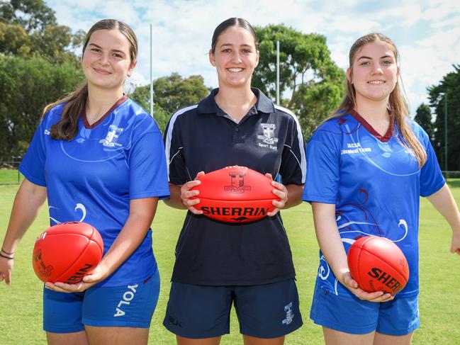 Former AFLW player Sarah Sansonetti with students Liana Georgiev and Abbey Mills, who she coaches in footy at her former school, Loyola College. Picture: Brendan Beckett