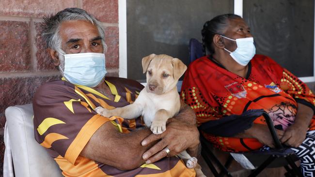 Lawrence Payne, wife Fenella and six-week-old puppy Trixy outside their house in Wilcannia. Picture: Chris Pavlich