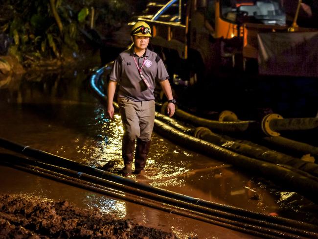 A rescuer walks between the hoses which pumped water out of the cave. Picture: Linh Pham/Getty Images.