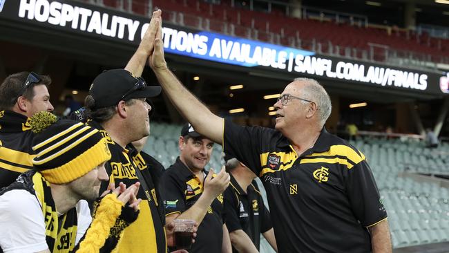 Legendary Glenelg player Peter "Super" Carey high fives fans after the Tigers won the SANFL preliminary final in 2019. Picture: Sarah Reed