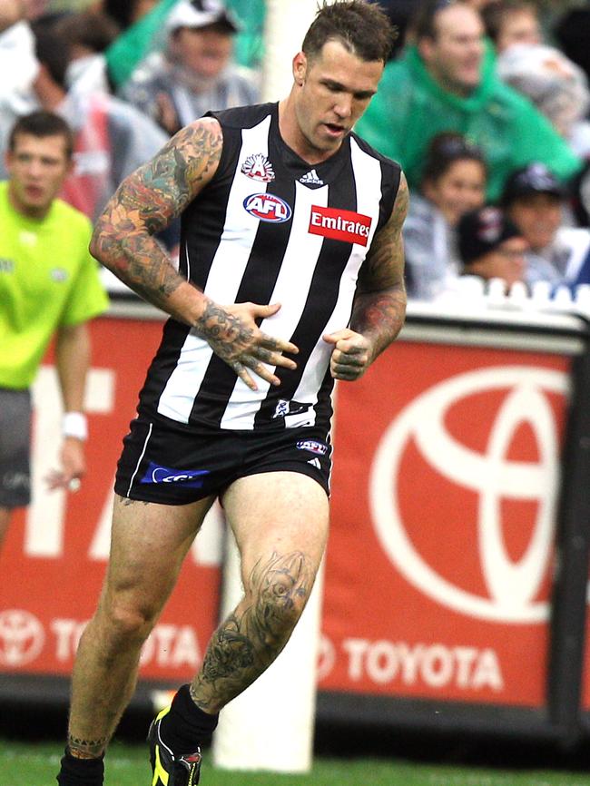 Dane Swan rubs his belly after kicking a goal in the third term.