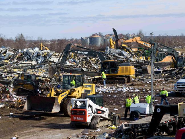 Workers toil through the destruction at Mayfield Consumer Products Candle Factory after it was destroyed by a tornado with workers inside, in Mayfield, Kentucky. Picture: AFP