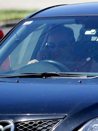 This car driver is talking on his phone while on the busy NSW Pacific Highway.