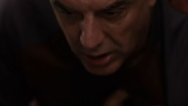 Mr Big (Chris Noth) clutches his arm after riding a Peloton bike and having a heart attack.