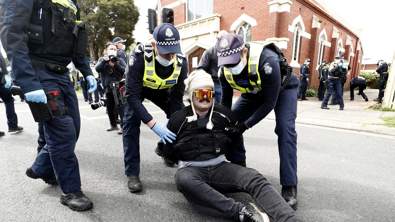 A man is arrested by police. (Photo by Darrian Traynor/Getty Images)
