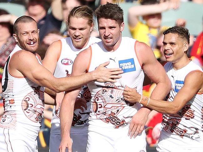 ADELAIDE, AUSTRALIA - MAY 01: GWS players get around Jesse Hogan after he kicked his first goal for the club during the 2021 AFL Round 07 match between the Adelaide Crows and the GWS Giants at Adelaide Oval on May 01, 2021 in Adelaide, Australia. (Photo by Sarah Reed/AFL Photos via Getty Images)