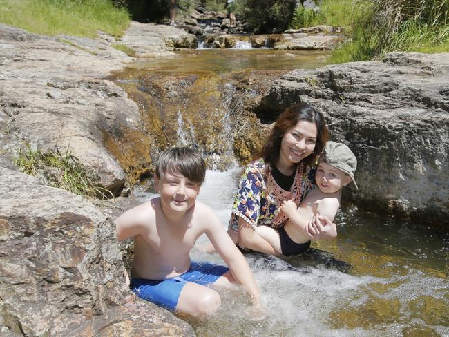 Warm weather pic. The Mercury is set to rise to 30 (thirty) degrees tomorrow. Enjoying an early taste of Summer at New Town rivulet, Lenah Valley are (L-R) Jacob Schultz (8), Fang Pradapthong (their mother), Flynn Schultz (3). Picture: MATT THOMPSON