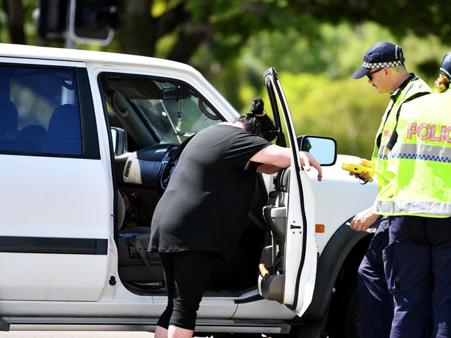 The driver being breath tested by police. Picture: Alix Sweeney