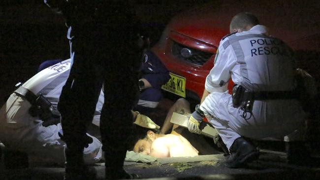 Police rescue a man stuck in drain in Camperdown.