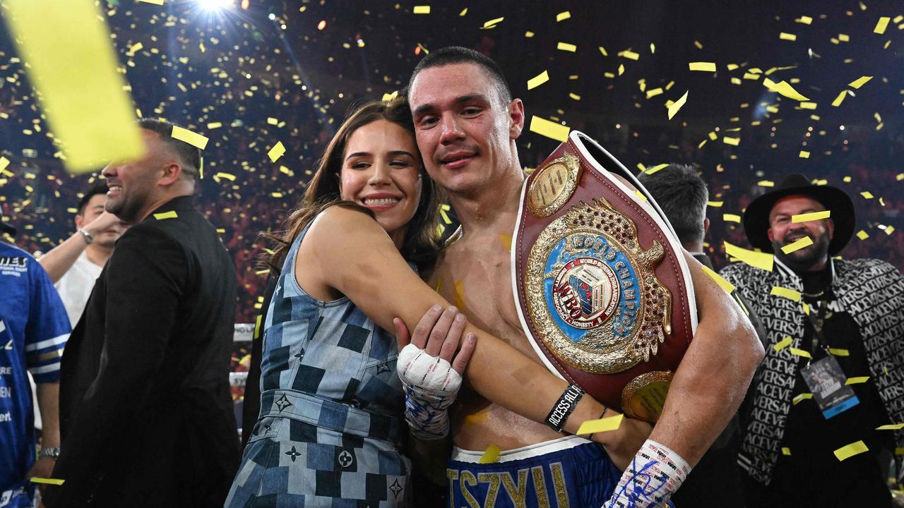 Australian boxer Tim Tszyu celebrates with his partner Alexandra Constantine following his victory over USA's Tony Harrison in their WBO super welterweight world title bout. (Photo by Saeed KHAN / AFP)