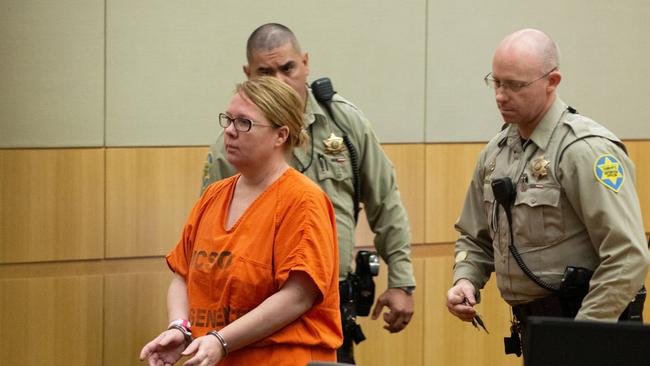 Adelaide expat Lisa Cunningham is escorted back to a holding cell by Maricopa County Sherriff's officers. Picture: Caitlin O'Hara/ News Corp Australia