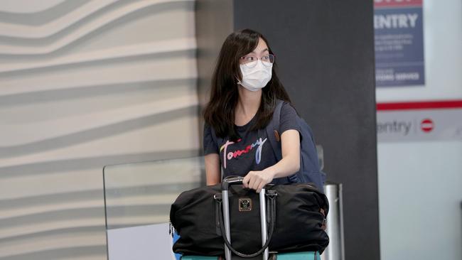 An air traveller wears a protective mask in the arrivals area at the international airport on January 29, 2020 in Auckland. Picture: Dave Rowland/Getty Images