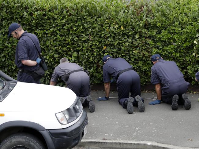 Police search for evidence at a motel near the Masjid Al Noor mosque in Christchurch. Picture: AP