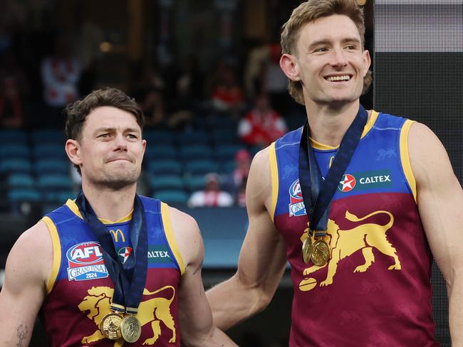 Brisbane Lions captains Lachie Neale and Harris Andrews together on the dais after winning the 2024 AFL Premiership. Picture Lachie Millard