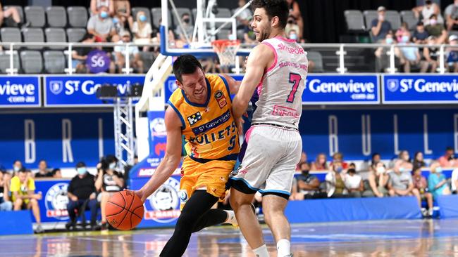 Jason Cadee is fouled by William McDowell-White during their match between Brisbane Bullets and New Zealand Breakers at Nissan Arena.