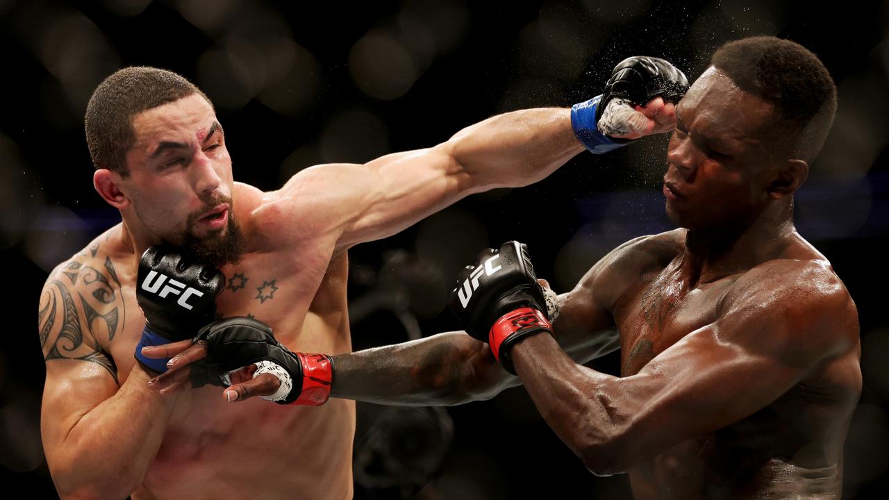 HOUSTON, TEXAS - FEBRUARY 12: Robert Whittaker of Australia punches Israel Adesanya of Nigeria in their middleweight championship fight during UFC 271 at Toyota Center on February 12, 2022 in Houston, Texas. (Photo by Carmen Mandato/Getty Images) ***BESTPIX***