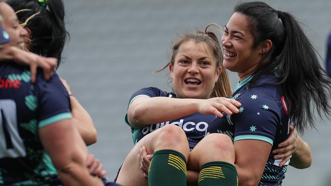 Captain Grace Hamilton (left) is held by Alysia Lefau-Fakaosilea of Australia during a Captain's Run.