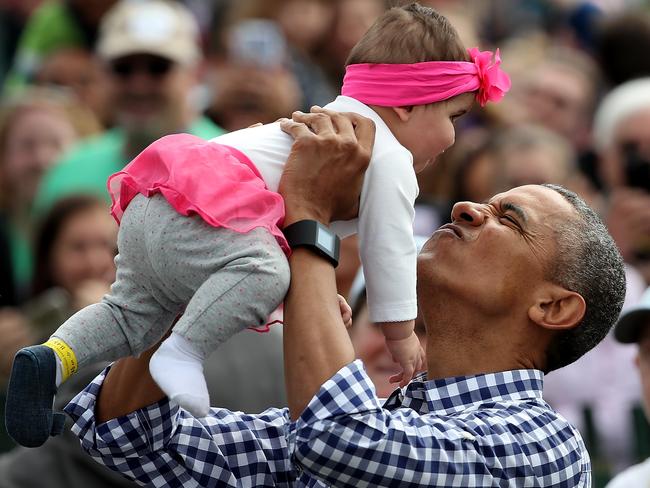 President Barack Obama lifts Stella Munoz into the air while greeting guests on the South Lawn of the White House during the annual White House Easter Egg Roll March 28, 2016 in Washington, DC. Picture: Win McNamee/Getty Images
