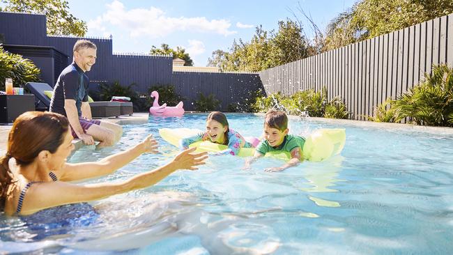 Generic shot of a family swimming in a clean pool.