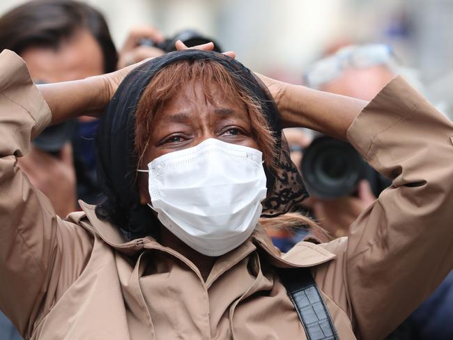 A relative of one of the victims at the scene. Picture: AFP