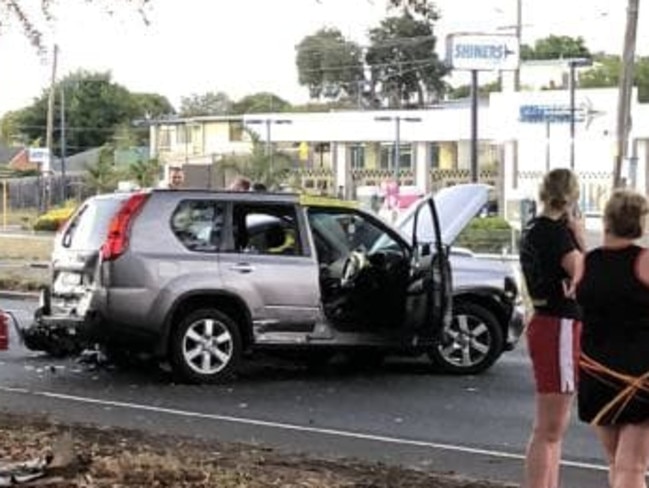 Onlookers at the scene of the carjacking.