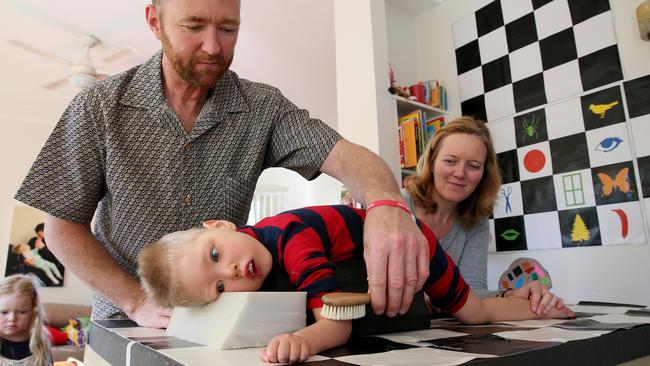 David &amp; Ina Mills give son Roki, 3, physical therapy at their Newport home. Picture: Troy Snook