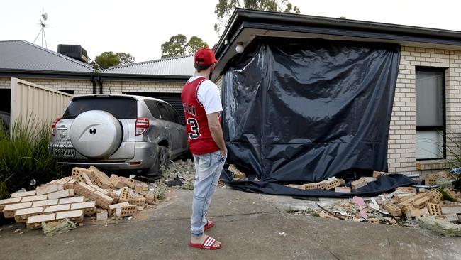 Adam Warner surveys the damage to his home. Picture: Naomi Jellicoe