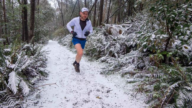 George Bujukovski braves the snow at Mt Macedon, going for a run up the track to Camel's Hump. Picture: Jay Town