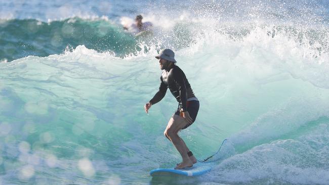 Surf’s up! The actor was seen climbing waves before working his way through a swell John Grainger