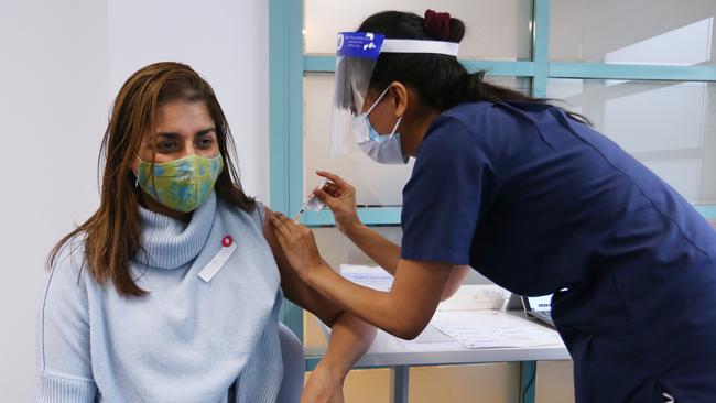 A nurse administers the Pfizer vaccine to a frontline worker.