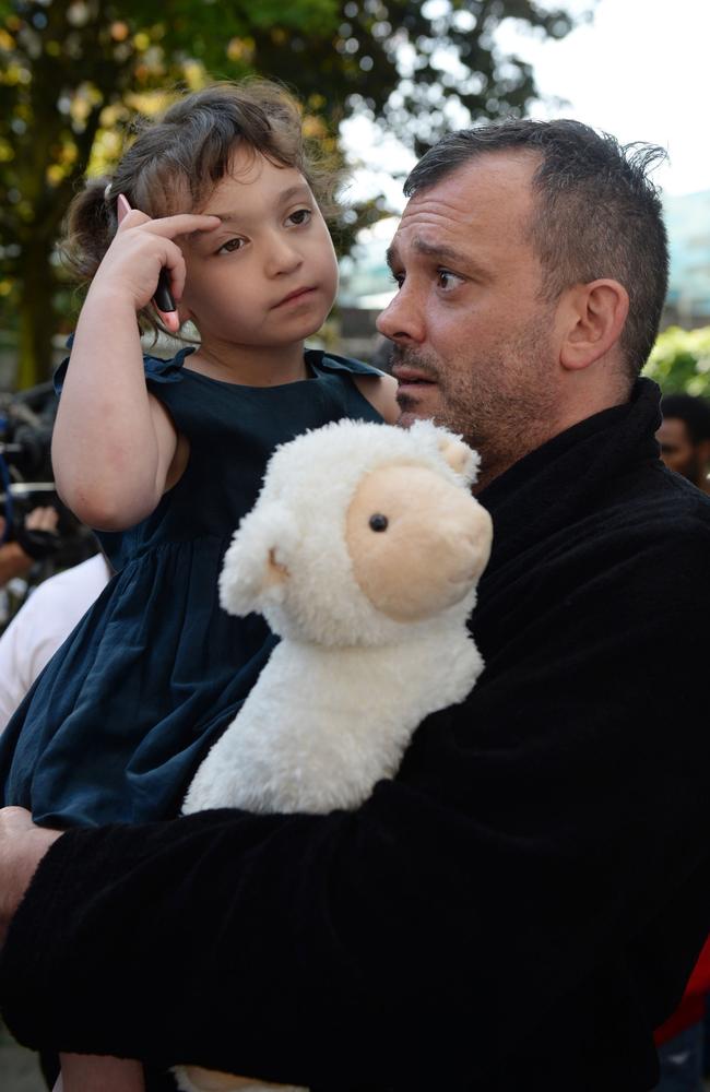 Resident Michael Paramasivan and his daughter Thea Kavanagh, 5, who escaped the inferno. Picture: AP