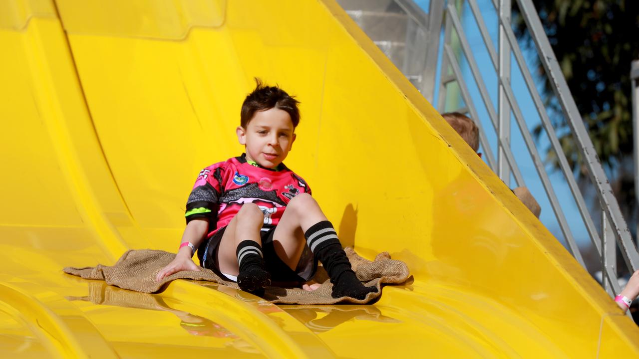 5 year old Cameron Cefai flies down the super slide at the Rouse Hill Rhinos Pink Day in Kellyville. (AAP IMAGE / Angelo Velardo)