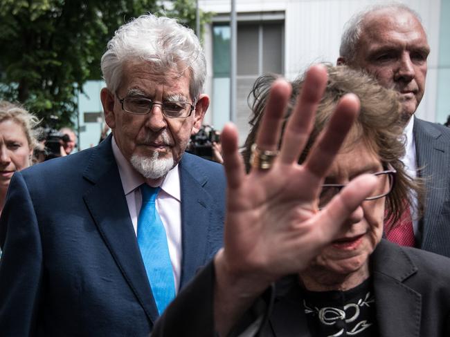 Former television entertainer Rolf Harris leaves Southwark Crown Court as his niece Jenny Harris lifts her hand in front of cameras. Harris has already served a jail sentence for molesting four girls aged between seven and 19. Picture: Carl Court / Getty