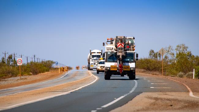 Trucks travel along a highway near Port Hedland. Photographer: Ian Waldie/Bloomberg