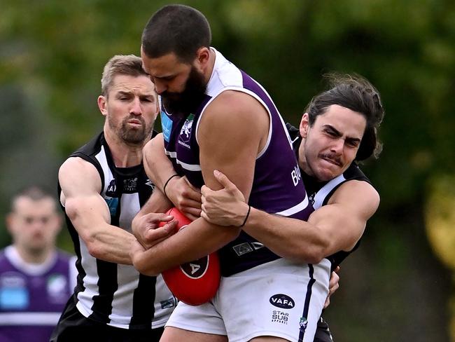 Ivanhoe’s Gerrard Williams tries to bring down Brunswick’s Adam Bevanda. Picture: Andy Brownbill