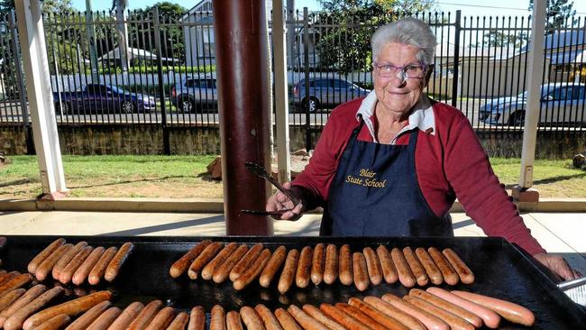 HAPPY HELPER: Rita Langer cooking up a treat at her familiar Blair State School barbecue. Picture: Rob Williams