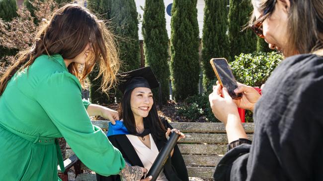 Master of Science graduate Aline dos Passos Silva is fussed over by friends Luiza Sartori (left) and Marcela Reis at her UniSQ graduation ceremony at Empire Theatres, Wednesday, June 28, 2023. Picture: Kevin Farmer