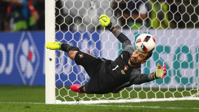 Portugal’s Rui Patricio makes a save during the shootout win over Poland.
