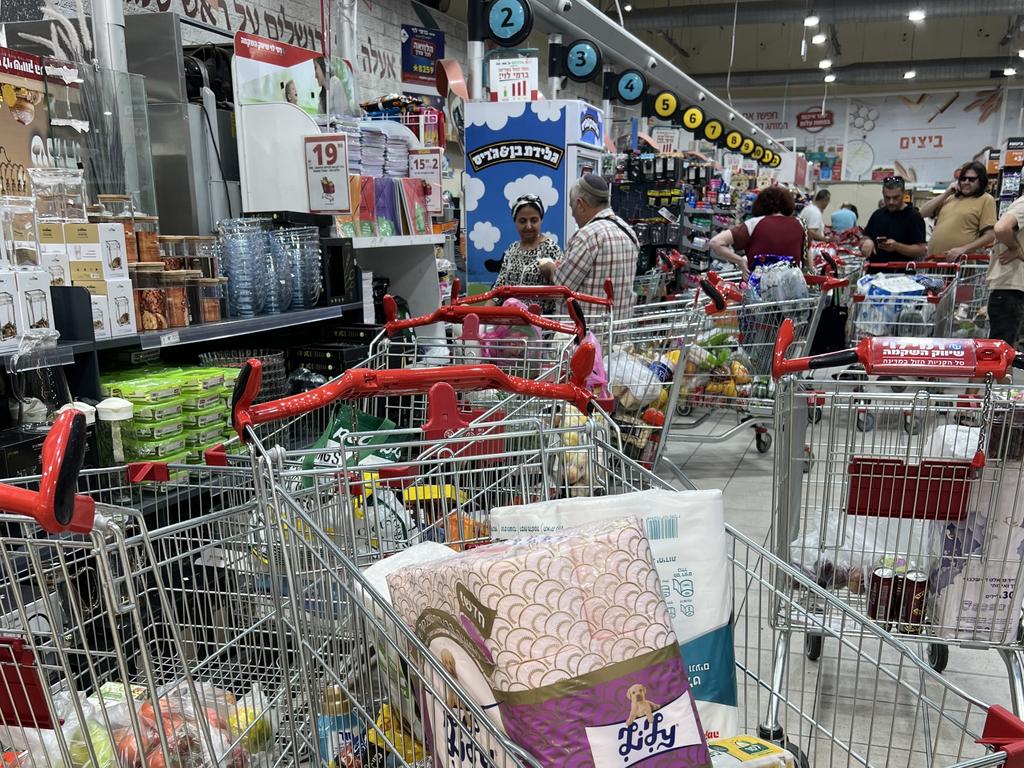 Panic buying at Rami Levy supermarket Tel Aviv. Shoppers abandon trolleys as bomb sirens sound. Picture: Danielle Gusmaroli