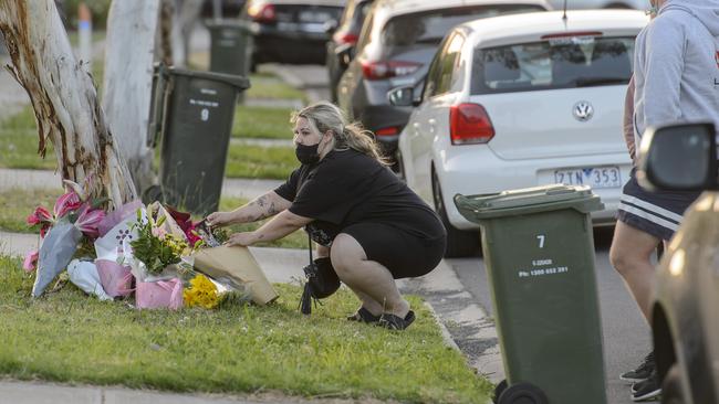 A person lays flowers at the scene. Picture: Jay Town