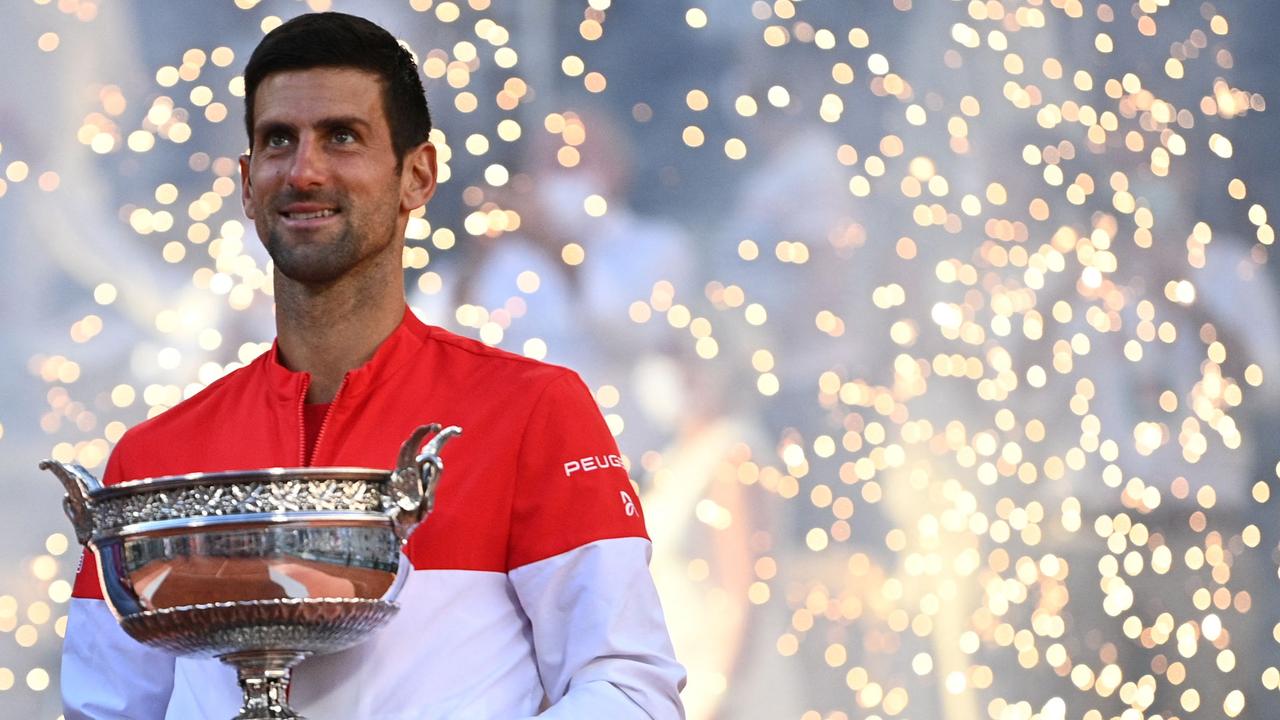 TOPSHOT - Serbia's Novak Djokovic poses with The Mousquetaires Cup (The Musketeers) after winning against Greece's Stefanos Tsitsipas at the end of their men's final tennis match on Day 15 of The Roland Garros 2021 French Open tennis tournament in Paris on June 13, 2021. (Photo by Anne-Christine POUJOULAT / AFP)