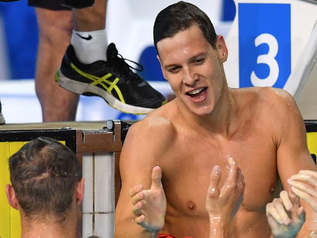 Mitch Larkin of Australia (right) celebrates with Bradley Woodward and Josh Beaver of Australia after winning the Menâ€™s 200m Backstroke Final on day five of swimming competition at the XXI Commonwealth Games at Gold Coast Aquatic Centre on the Gold Coast, Australia, Monday, April 9, 2018.  (AAP Image/Darren England) NO ARCHVIING, EDITORIAL USE ONLY