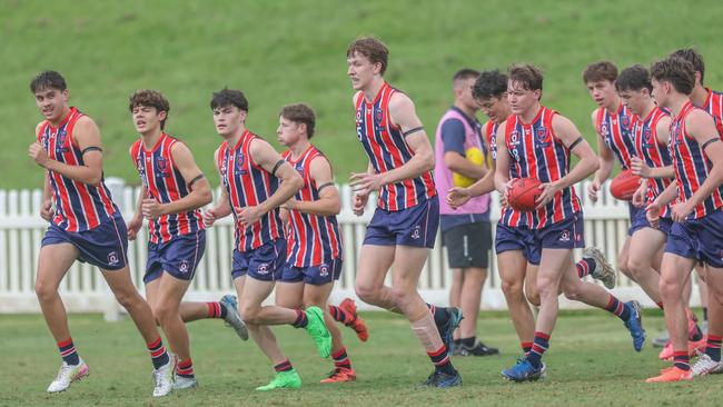 Wilston Grange captain Austin Segon, right with ball, and teammates. Photos by Stephen Archer