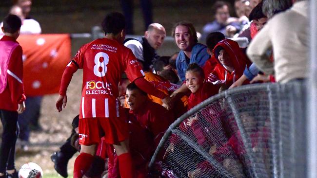 The fence collapses as Olympic FC fans celebrate a goal. Picture: Getty Images